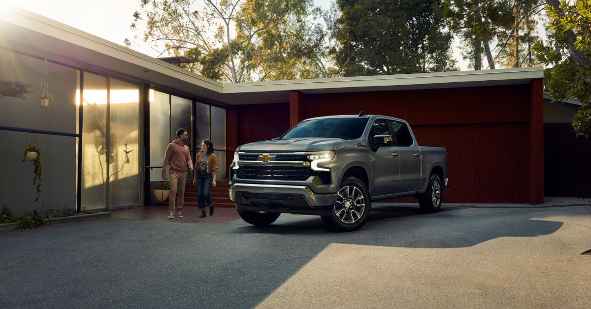 2025 Chevy Silverado 1500 parked in a driveway while a couple walks beside it